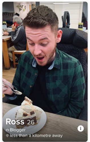 Ross in a restaurant pulling a funny face as he dips into a slice of cake
