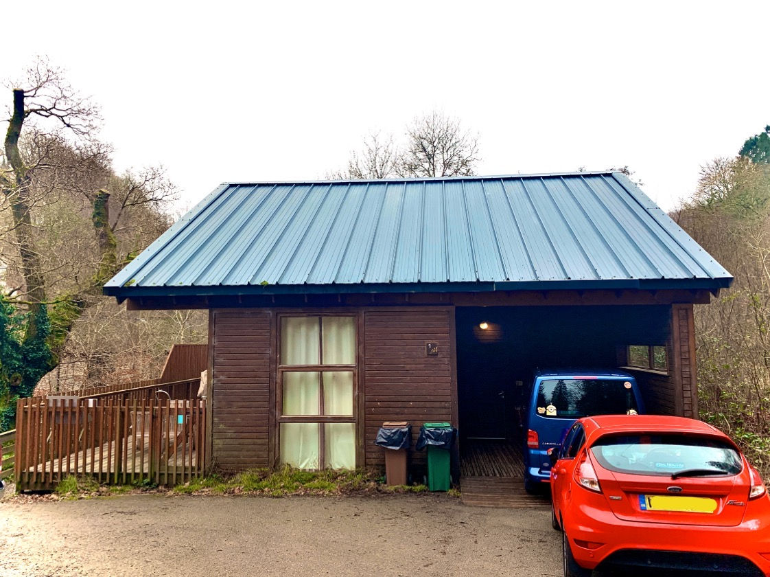 Outside view of our cabin, showing two cars parked