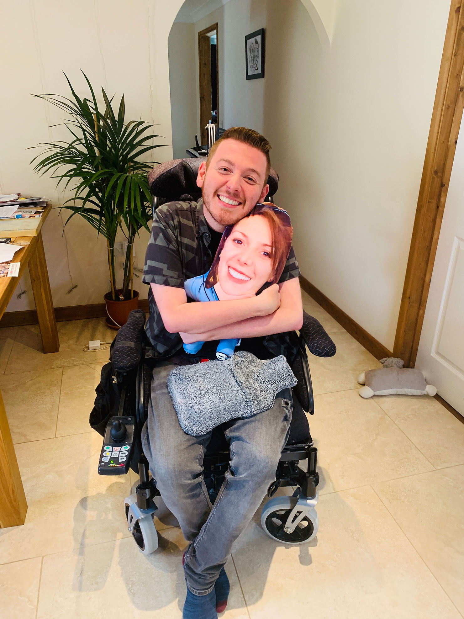 Ross squeezing a pillow with his sister's face on it