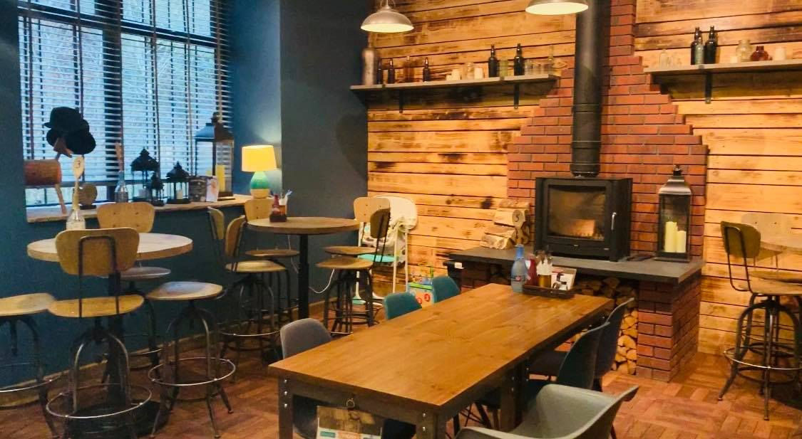 Forest Hub reception area dining tables, with red brick fireplace