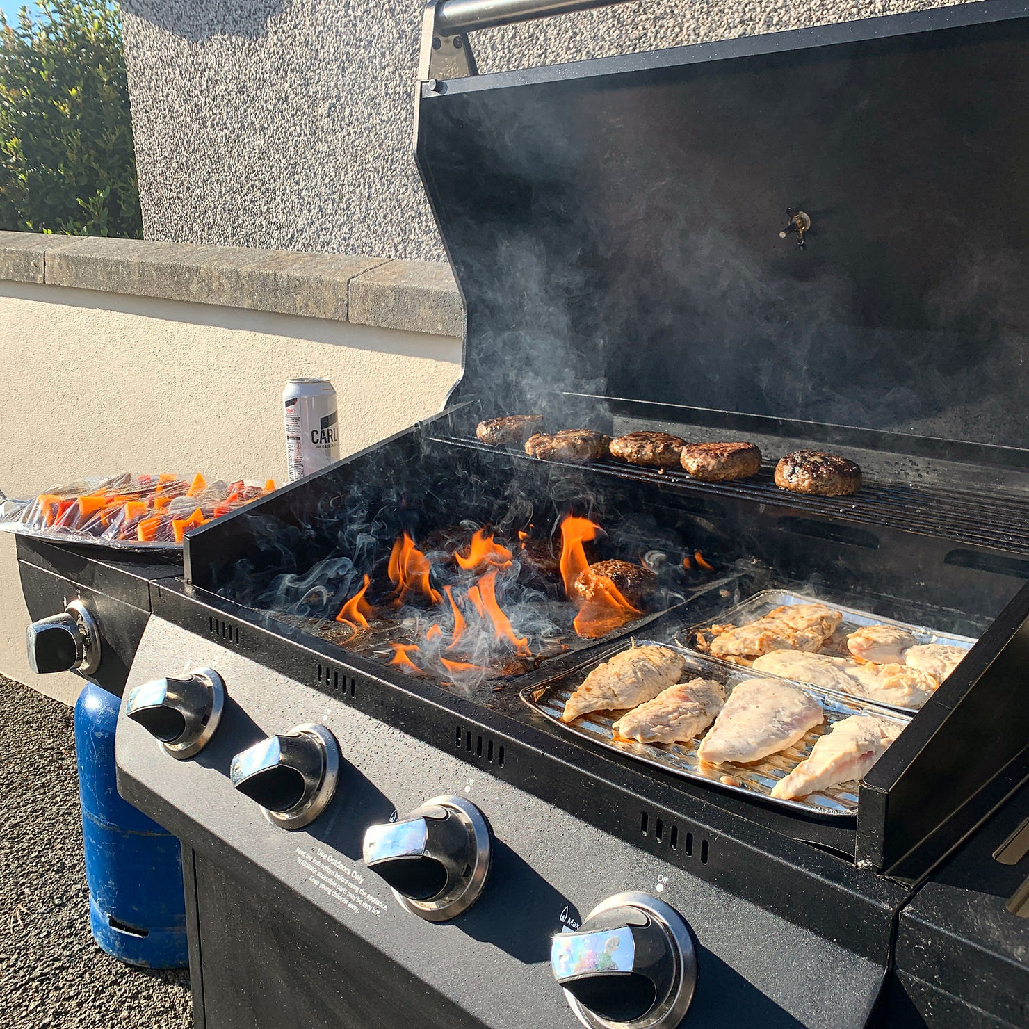 BBQ on fire, flames smoking off the burger grill