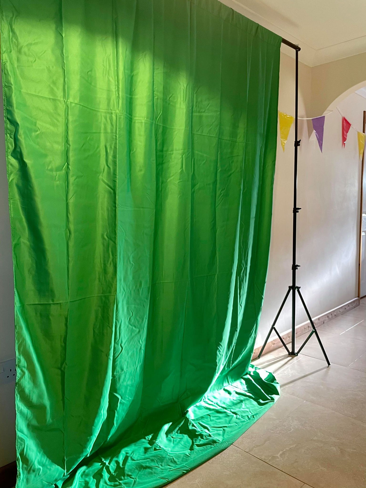 Large green screen backdrop in Ross's hallway