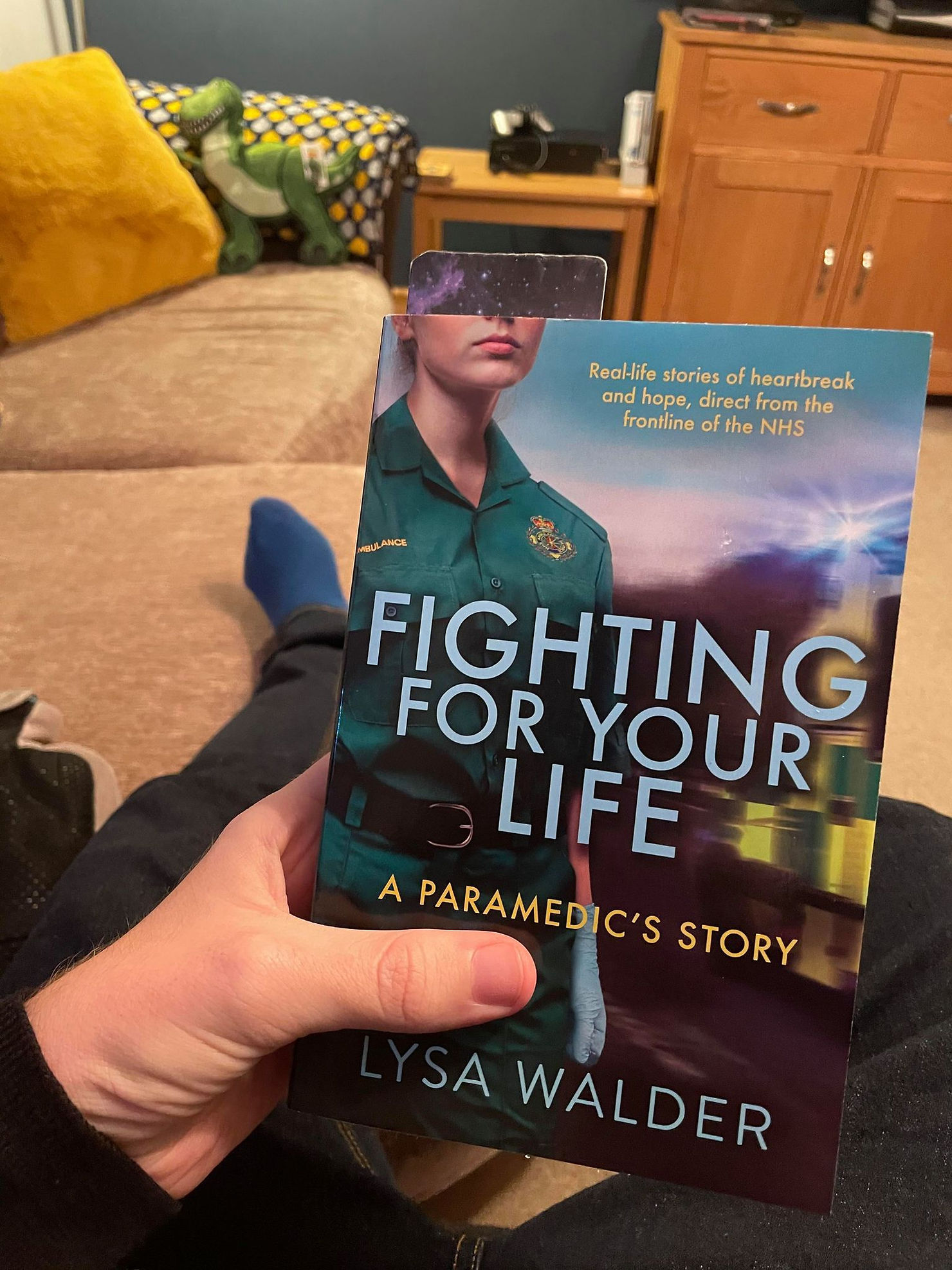 Ross's lap holding a book called "fighting for your life" by Lysa Walder