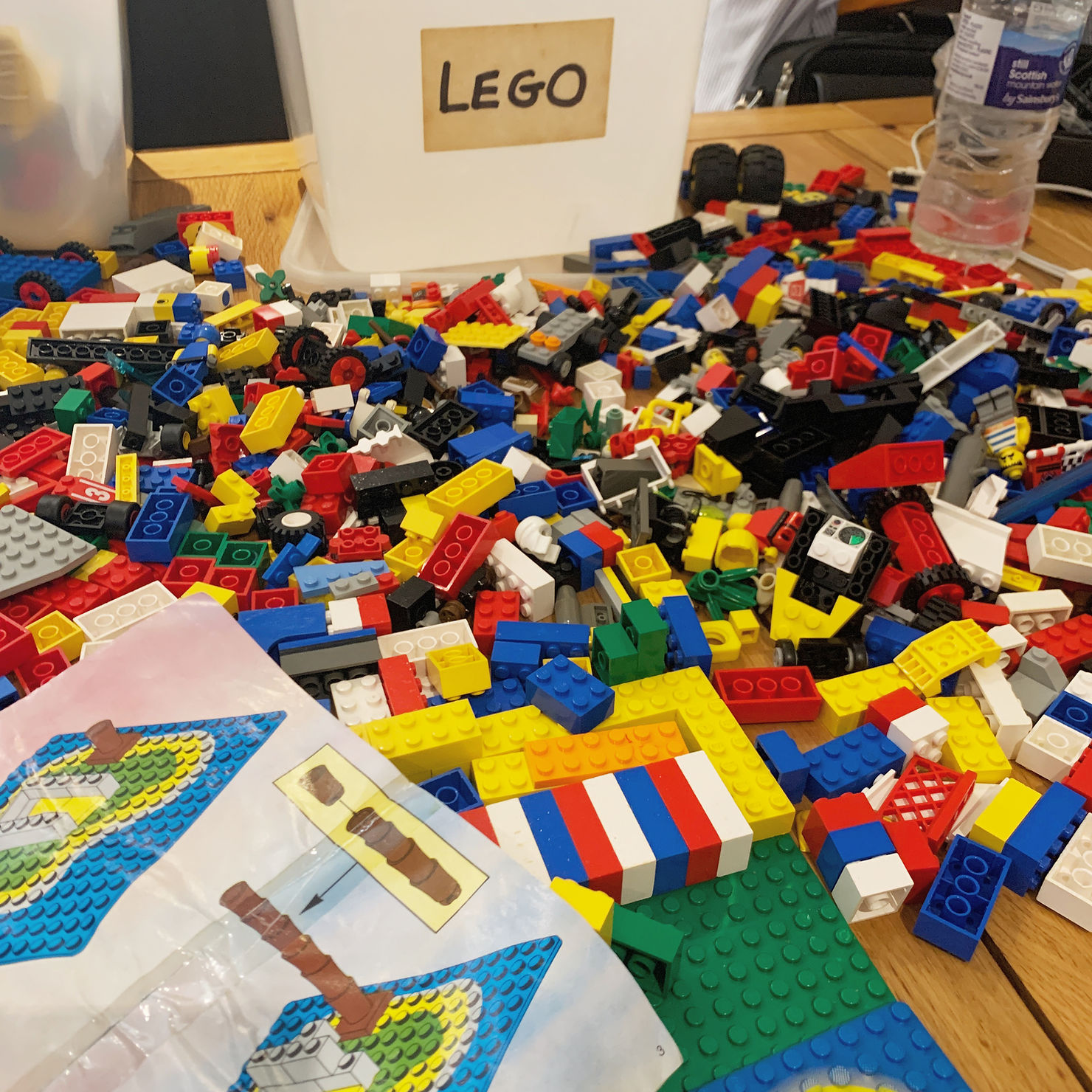 Ross's kitchen table covered in a multicoloured mess of lego pieces