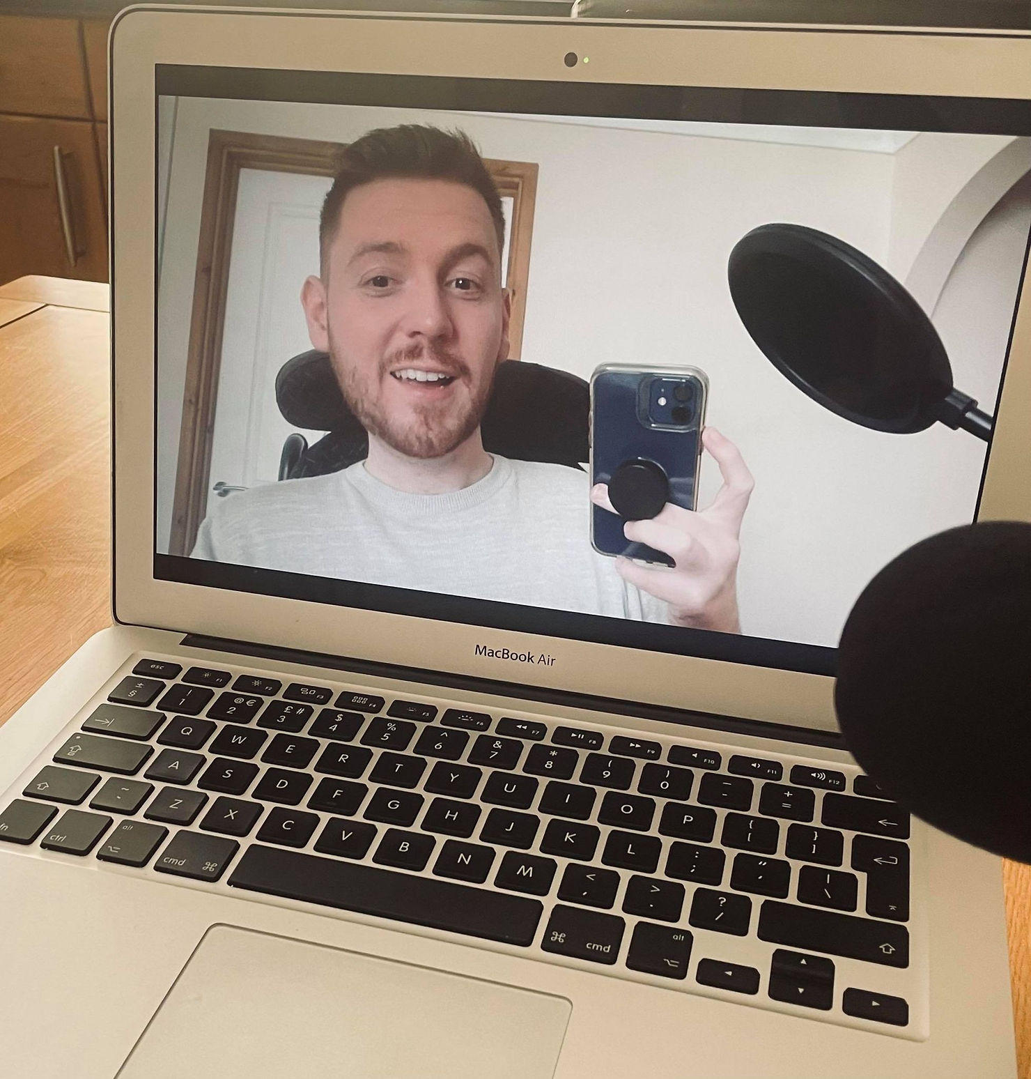 Ross taking a selfie of his face through the Zoom camera on his laptop