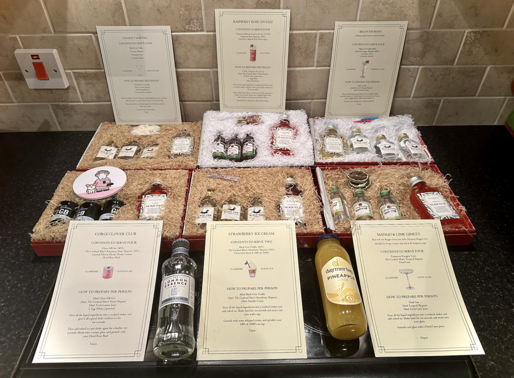 6 months worth of cocktail delivery boxes laid out on Ross's counter